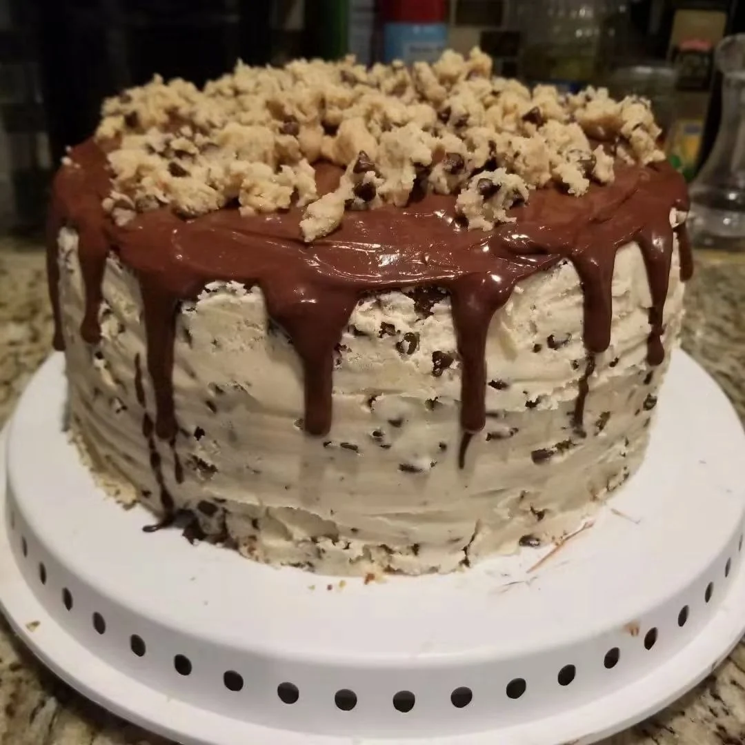 Chocolate-chip cake with chocolate drips and a generous topping
